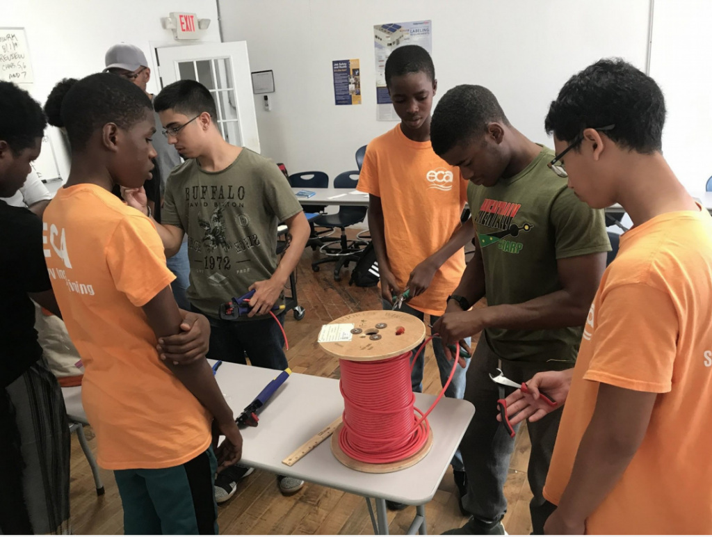 Students working on cutting wires for solar panels